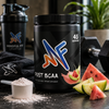 Mindful Post BCAA powder in a gym lifestyle setup with fruit, scoop, and workout accessories